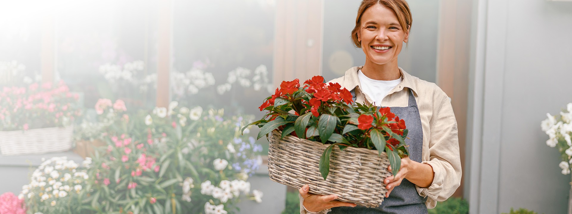 Smiling woman holding red flowers