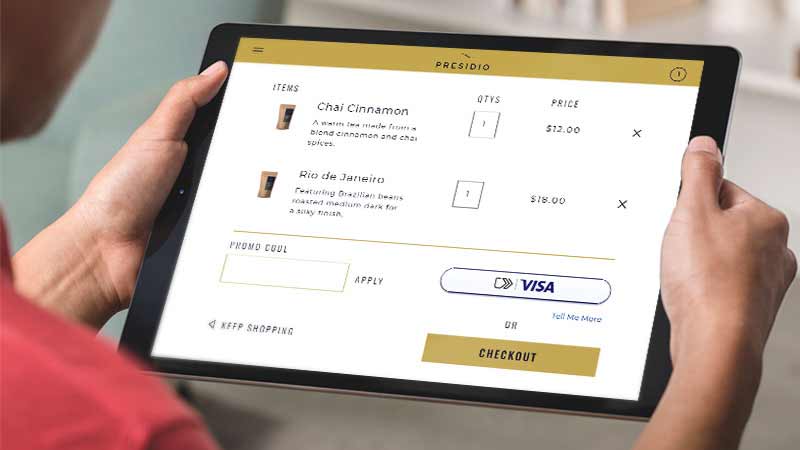 holding-tablet-800x450 A woman holds a tablet that displays the new checkout experience.